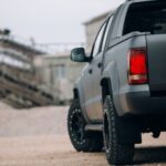 A gray truck waits for its next hot shot trucking load.