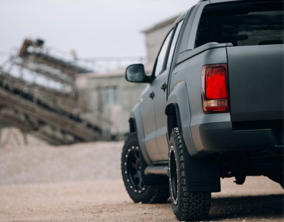 A gray truck waits for its next hot shot trucking load.